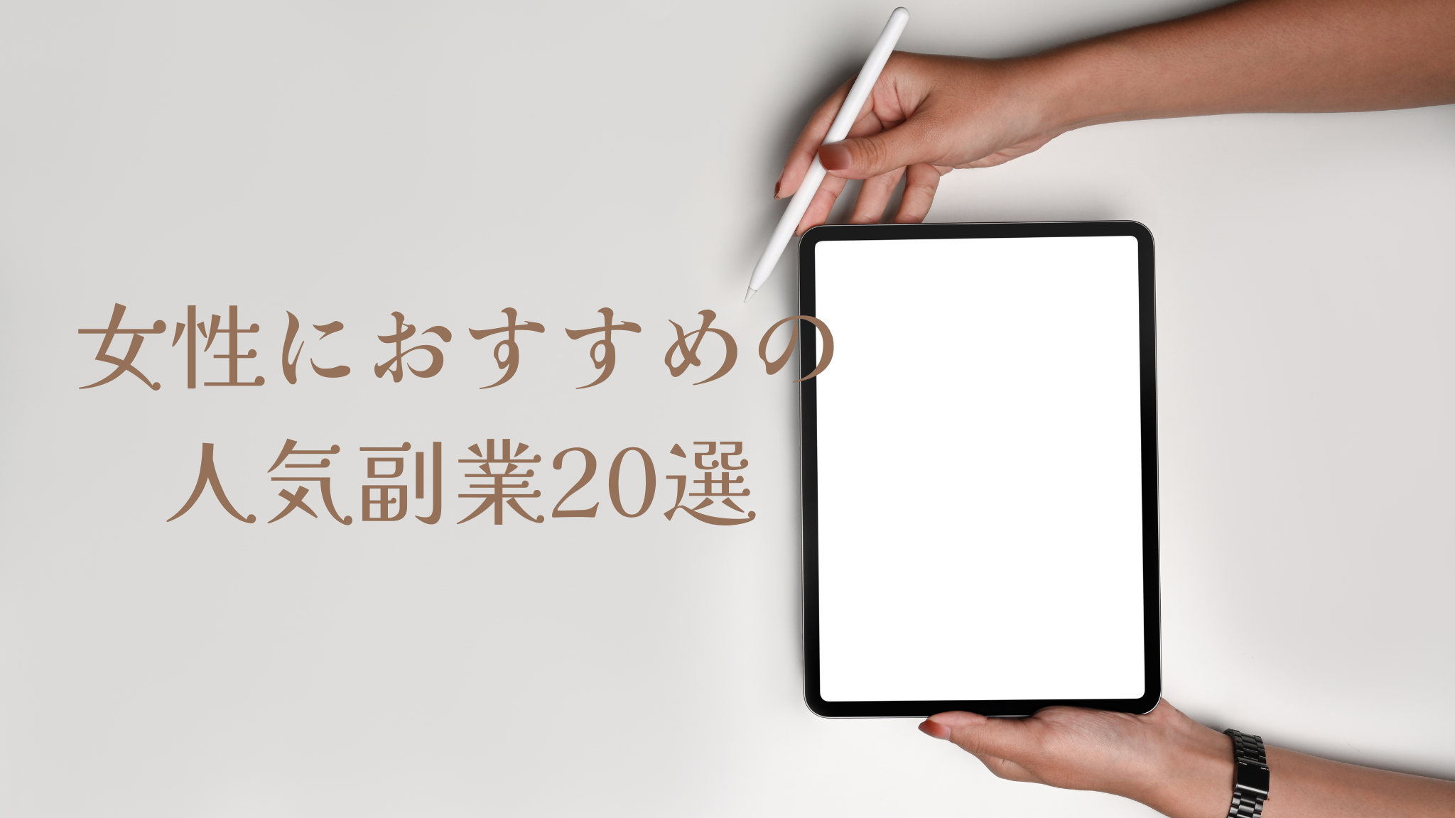 グレージュの背景に、白い画面のタブレットを両手で持っている女性の手元